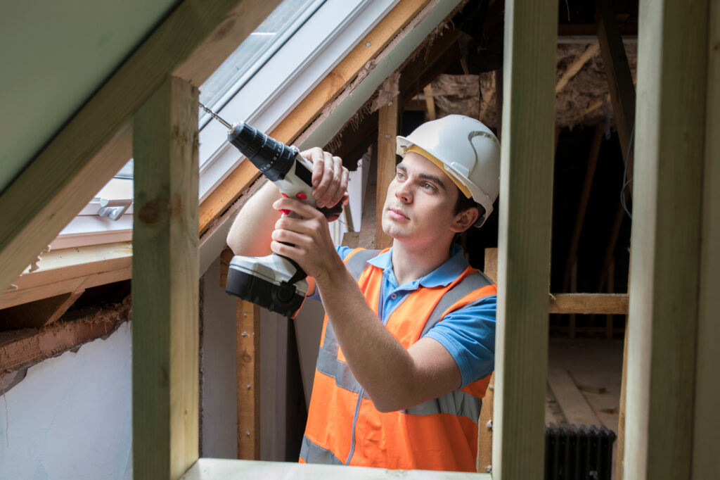 Roofer installing Velux Window in attic conversion, Aberdeen